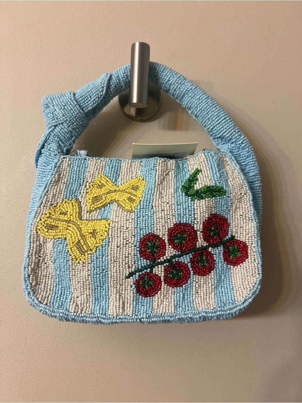 Sol & Mer beaded bag features a unique blue-and-white striped pattern